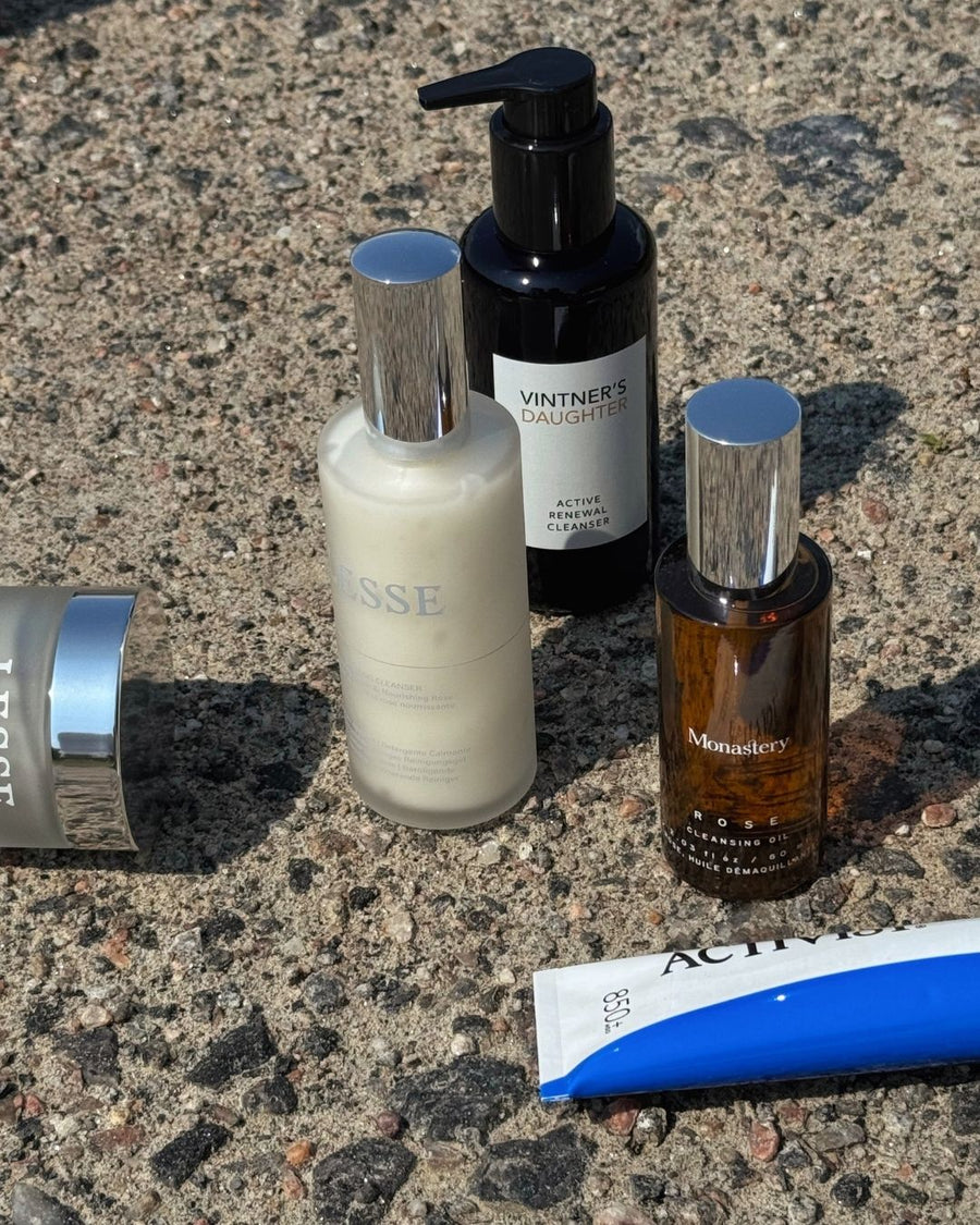 Bottles of cleansers and jar and tube of masks good for sunburnt skin