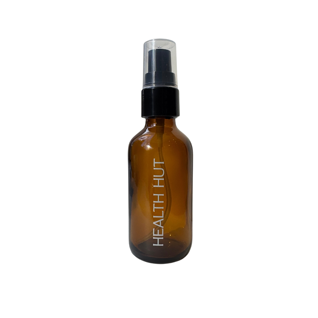 A brown glass travel bottle with a black spray nozzle, labeled 'Health Hut'.