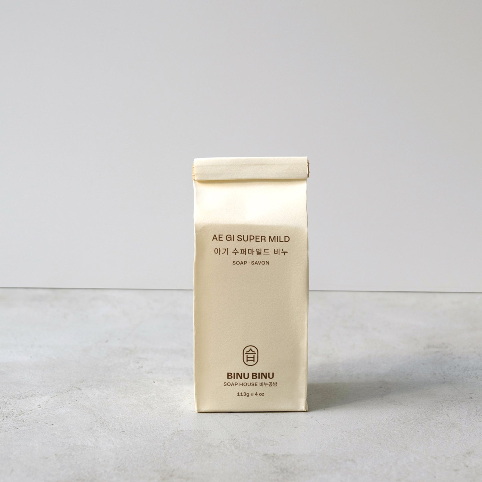 Beige packaging of AE SI SUPER MILD on a light gray background